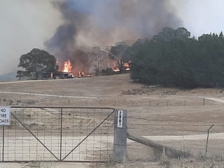 Good Good Fire, major fire burning behind a house